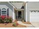 Close-up of the front entrance with vibrant flowers, house number, and covered entryway at 4323 Wiregrass Rd, Indian Land, SC 29707