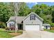 Charming home with a two-car garage, complemented by lush landscaping and a cozy shed at 4323 Wiregrass Rd, Indian Land, SC 29707