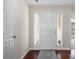 Hallway showcasing wood floors, the front door, and ample natural light at 4323 Wiregrass Rd, Indian Land, SC 29707