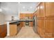 Charming kitchen with wood cabinetry, stainless steel appliances, and a breakfast bar at 4323 Wiregrass Rd, Indian Land, SC 29707