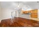 Open-concept living space with hardwood floors and kitchen with wood cabinets at 4323 Wiregrass Rd, Indian Land, SC 29707