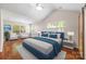 Bright main bedroom with vaulted ceiling, wood floors, and large windows at 4323 Wiregrass Rd, Indian Land, SC 29707