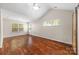 Bright main bedroom with vaulted ceiling, wood floors, and large windows at 4323 Wiregrass Rd, Indian Land, SC 29707