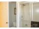 Bathroom featuring a shower with glass doors, white tile, and a white toilet at 4626 Annerly Ct, Charlotte, NC 28226