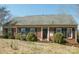 Charming brick home featuring blue shutters and a well-manicured lawn at 4626 Annerly Ct, Charlotte, NC 28226