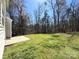 Grassy backyard with a treeline and side of the home at 5011 Abercromby St, Charlotte, NC 28213