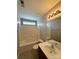 Bathroom with white tub and shower combination and neutral paint at 5011 Abercromby St, Charlotte, NC 28213