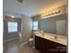 Bright bathroom with double vanity, tile floor, and window for natural light at 5011 Abercromby St, Charlotte, NC 28213