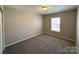 Carpeted bedroom with a bright window and neutral paint at 5011 Abercromby St, Charlotte, NC 28213