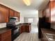 Modern kitchen with dark cabinets, bar seating, and stainless steel microwave at 5011 Abercromby St, Charlotte, NC 28213