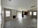 Open living room with fireplace, seamlessly connected to the modern kitchen area at 5011 Abercromby St, Charlotte, NC 28213