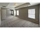 Bright main bedroom featuring tray ceiling and carpet floors at 5011 Abercromby St, Charlotte, NC 28213