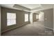 Serene main bedroom featuring a tray ceiling, neutral walls, and carpet floors at 5011 Abercromby St, Charlotte, NC 28213