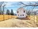 View of the back of the white house, fenced in yard with a concrete patio at 515 Harrel St, Salisbury, NC 28144