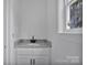 Modern bathroom with white cabinets and granite countertop, offering a clean aesthetic at 515 Harrel St, Salisbury, NC 28144