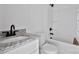 A bathroom features a granite vanity countertop, a toilet, and a bathtub with matte black hardware at 515 Harrel St, Salisbury, NC 28144