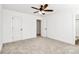 Comfortable bedroom with neutral carpet, ceiling fan, and doorway to bath at 515 Harrel St, Salisbury, NC 28144