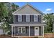 Charming two-story home with gray siding, black shutters, and a welcoming front porch at 515 Harrel St, Salisbury, NC 28144