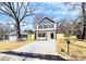 Attractive two-story home featuring a new driveway, stylish black shutters, and a newly installed fence at 515 Harrel St, Salisbury, NC 28144