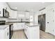 Modern kitchen with white cabinets, granite countertops, a kitchen island, and stainless steel appliances at 515 Harrel St, Salisbury, NC 28144