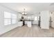 Modern kitchen with white cabinetry, stainless steel appliances, and granite countertops, island, and bright lighting at 515 Harrel St, Salisbury, NC 28144