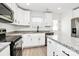 Close-up of a modern kitchen with granite countertops, white cabinetry, and stainless steel appliances at 515 Harrel St, Salisbury, NC 28144