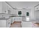 Bright kitchen featuring white cabinets, gray countertops, an island, and stainless steel dishwasher at 515 Harrel St, Salisbury, NC 28144