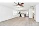 Bright open-concept living area with light-colored flooring, a modern fan, and a view into the kitchen at 515 Harrel St, Salisbury, NC 28144