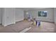 Bright, unfinished living room with a large window showcasing the yard view at 515 Harrel St, Salisbury, NC 28144