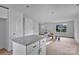 Open-concept, unfinished area next to the kitchen with natural light from the window at 515 Harrel St, Salisbury, NC 28144
