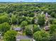 An aerial shot shows a quiet, residential neighborhood in a lush, green setting with mature trees at 5316 Rupert Ln, Charlotte, NC 28215
