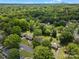 Serene aerial view showcases a neighborhood surrounded by lush greenery near city skyline at 5316 Rupert Ln, Charlotte, NC 28215