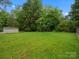 Expansive, grassy backyard with mature trees, offering ample space for recreation and relaxation at 5316 Rupert Ln, Charlotte, NC 28215