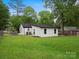Well-maintained backyard featuring a white home with black trim, and a spacious lawn at 5316 Rupert Ln, Charlotte, NC 28215