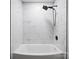 Shower with marble subway tile surround, rainfall shower head and white tub at 5316 Rupert Ln, Charlotte, NC 28215
