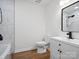 Bathroom features marble wall tiles, modern vanity, black fixtures, and wood floor at 5316 Rupert Ln, Charlotte, NC 28215