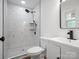 Bathroom featuring marble tiled shower, black fixtures, white vanity and black framed mirror at 5316 Rupert Ln, Charlotte, NC 28215