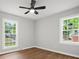 Bedroom with ceiling fan, light grey walls, wood floors and dual windows providing ample natural light at 5316 Rupert Ln, Charlotte, NC 28215