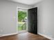 Freshly painted foyer showcasing sleek new hardwood flooring and modern lighting at 5316 Rupert Ln, Charlotte, NC 28215