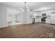 Open kitchen with stainless steel appliances and an adjacent sitting room at 5316 Rupert Ln, Charlotte, NC 28215