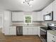 Corner view of a modern kitchen with stainless steel appliances and granite countertops at 5316 Rupert Ln, Charlotte, NC 28215