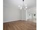 Bright living room showcasing an open-concept design and a modern light fixture at 5316 Rupert Ln, Charlotte, NC 28215