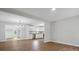 Open floor plan view into modern kitchen from the living room, featuring new flooring and paint at 5316 Rupert Ln, Charlotte, NC 28215