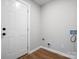 Mud room featuring a white door, wood-look flooring, and utility hookup at 5316 Rupert Ln, Charlotte, NC 28215