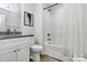 Clean bathroom features granite counters, updated hardware, and a shower over tub at 5524 Howard St, Charlotte, NC 28269