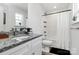 Bright bathroom features granite counters, a shower over tub and modern fixtures at 5524 Howard St, Charlotte, NC 28269