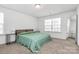 Cozy bedroom with neutral tones, ample natural light, and a comfortable bed setup at 5524 Howard St, Charlotte, NC 28269