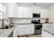 This well-equipped kitchen features granite countertops, stainless steel appliances, and ample cabinet space at 5524 Howard St, Charlotte, NC 28269