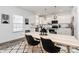 Kitchen dining area with modern appliances, granite counters, central island with pendant lighting at 5524 Howard St, Charlotte, NC 28269