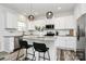 Bright kitchen features granite counters, stainless appliances, a central island, and bar stool seating at 5524 Howard St, Charlotte, NC 28269